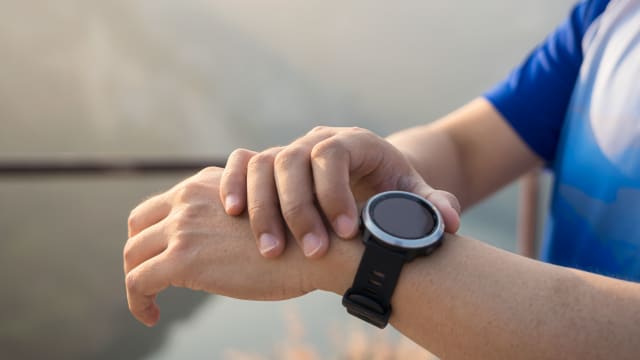 Shot of a man checking his fitness tracker after a run.