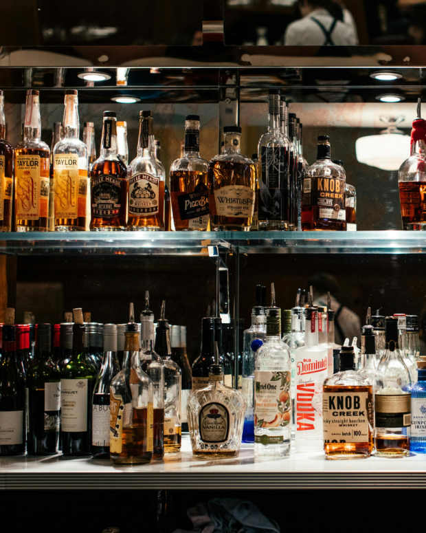 Whiskeys on a bar shelf.