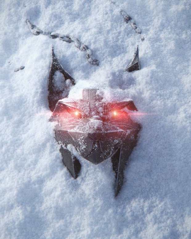 A lynx medallion lying in the snow.