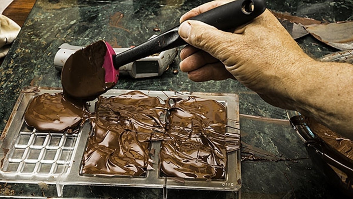 Artisan Chocolate Making Adding Cocoa Grits In The Melanger Stone