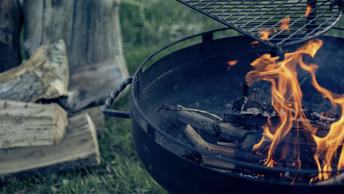 Enjoy Your Backyard More With This Barebones Cowboy Firepit Grill In It