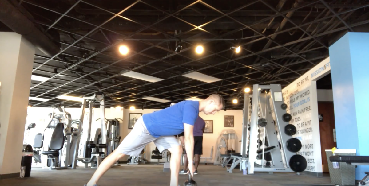 Starting position of the sliding leg curl. The hips are lifted into
