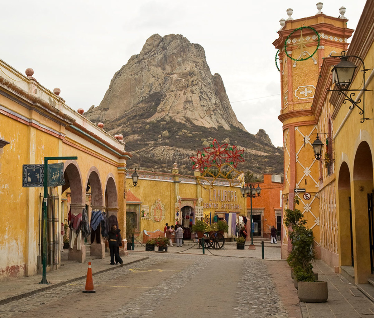 Street in Querétero, Mexico, with Peña de Bernal monolith in the background.