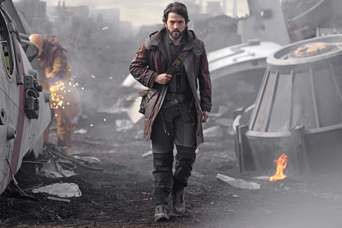 Diego Luna as Cassian Andor strides amongst wreckage.