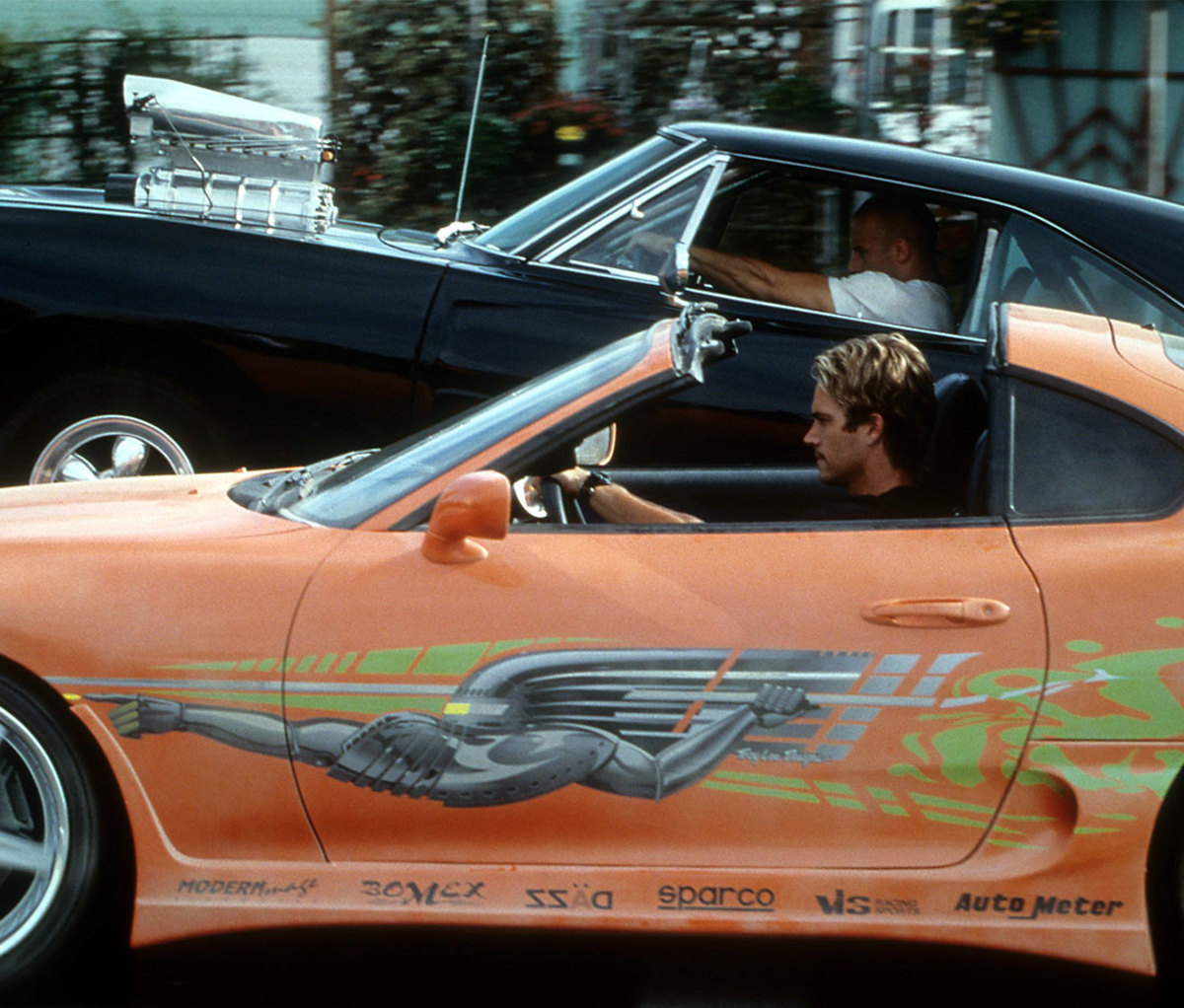 Vin Diesel and Paul Walker racing against each other in a scene from the film 'The Fast And The Furious', 2001.