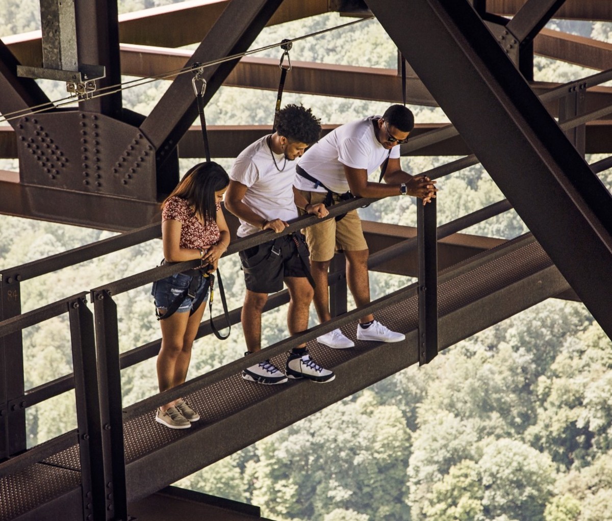 Young adults walking over bridge