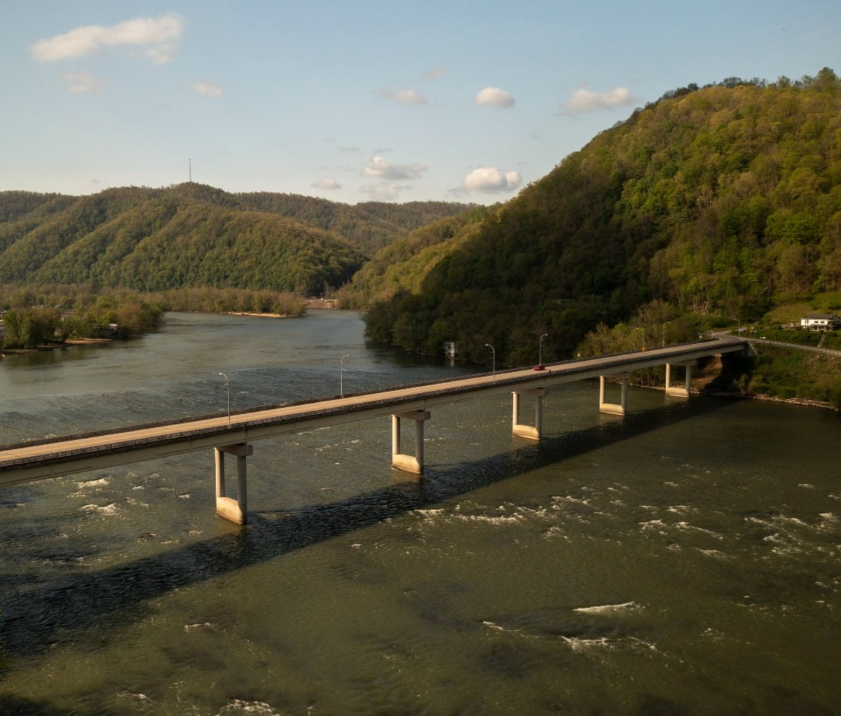 Bridge over water with nearby wooded area