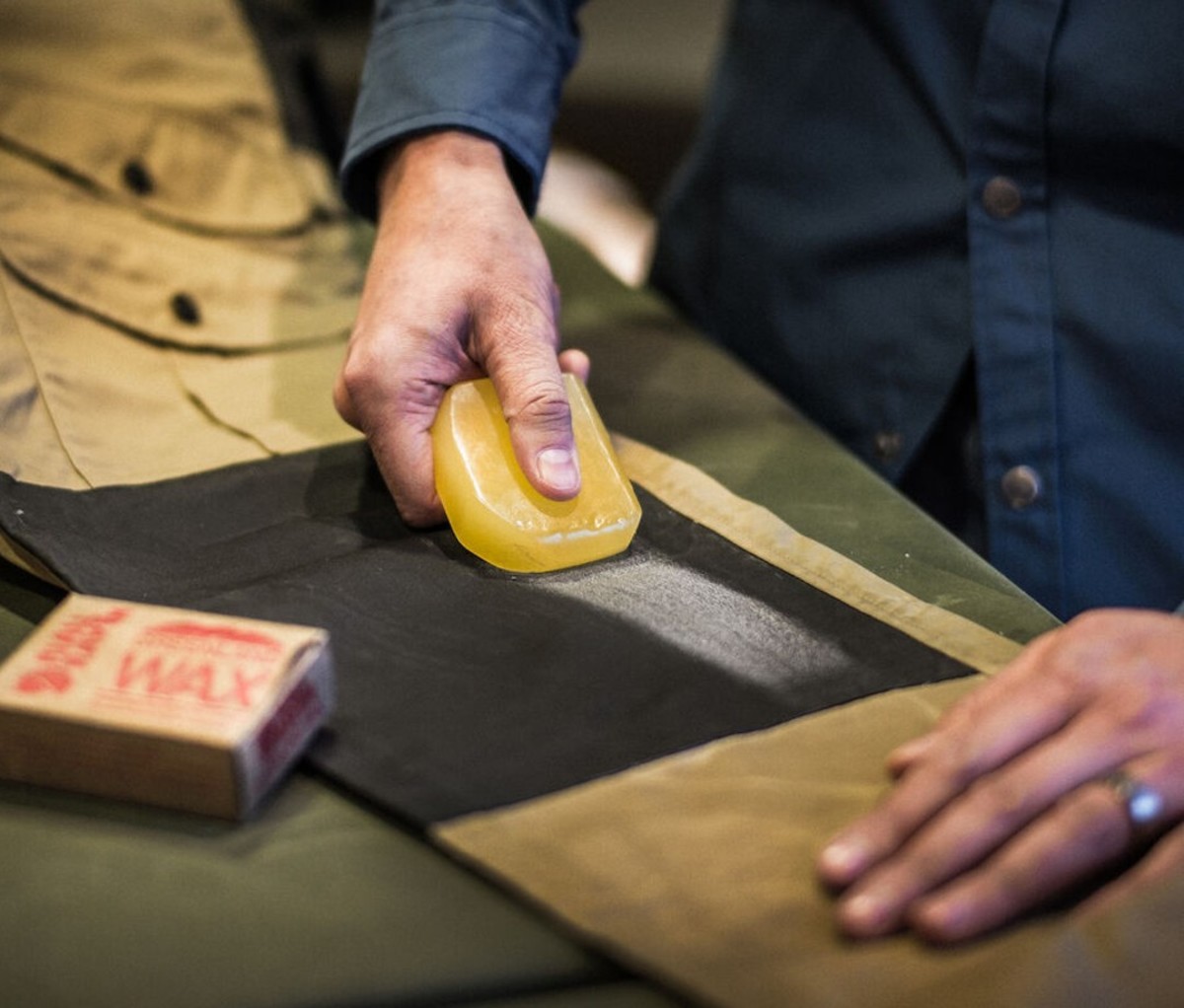 Man waxing jacket