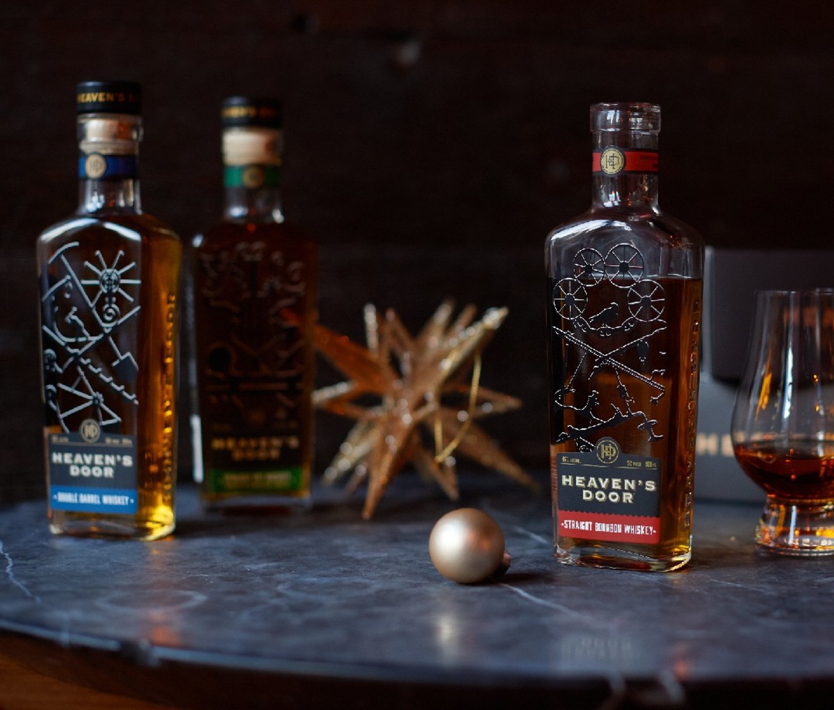 Bottles of whiskey on table with holiday ornaments