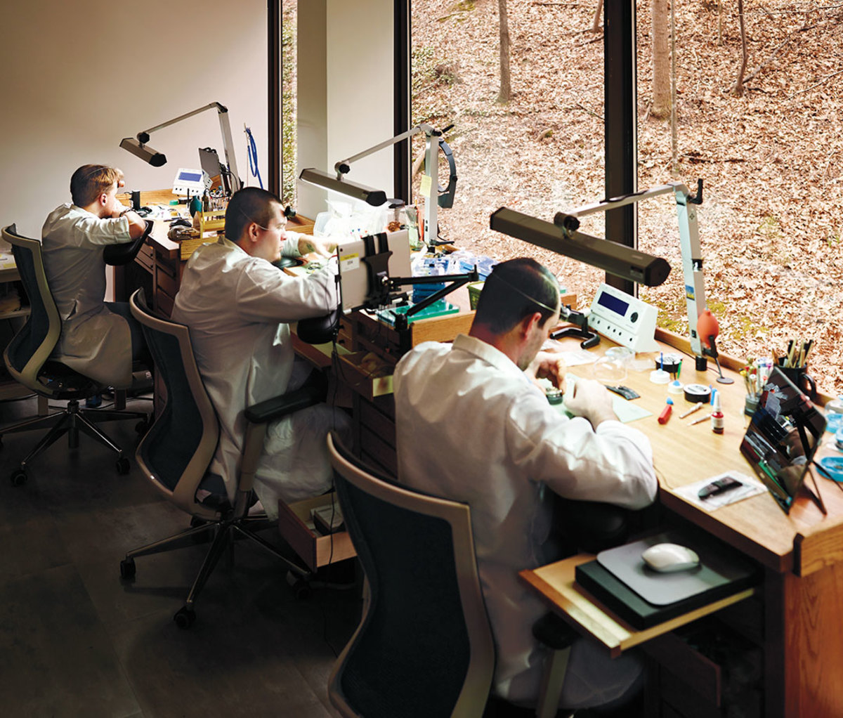 technicians and watchmakers in the company's workshop