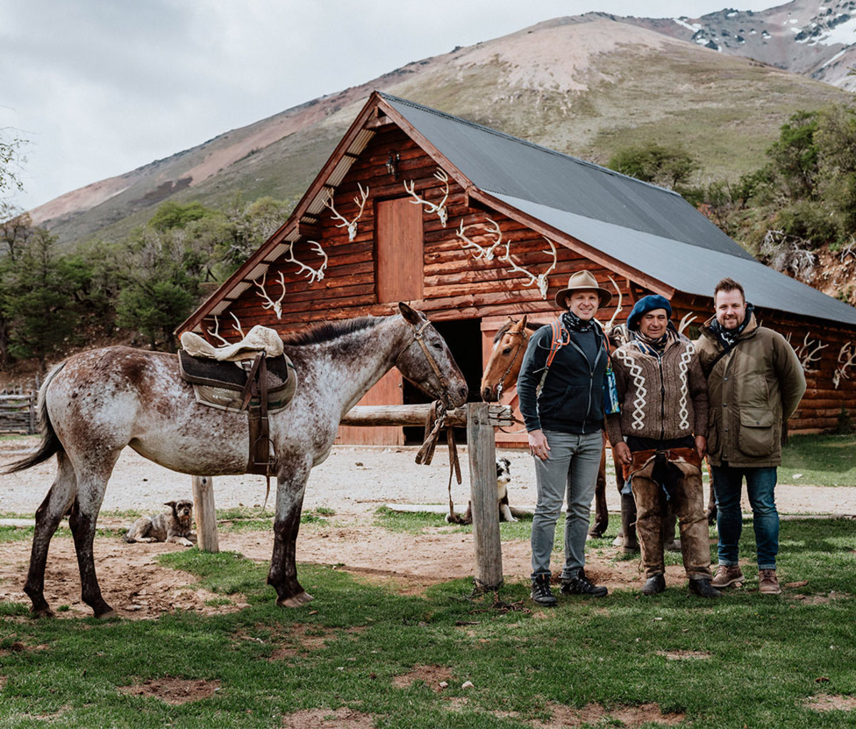 Men standing outside of cabin