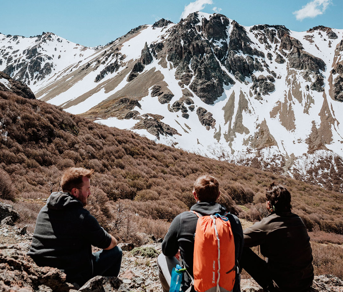 Men looking up at mountains