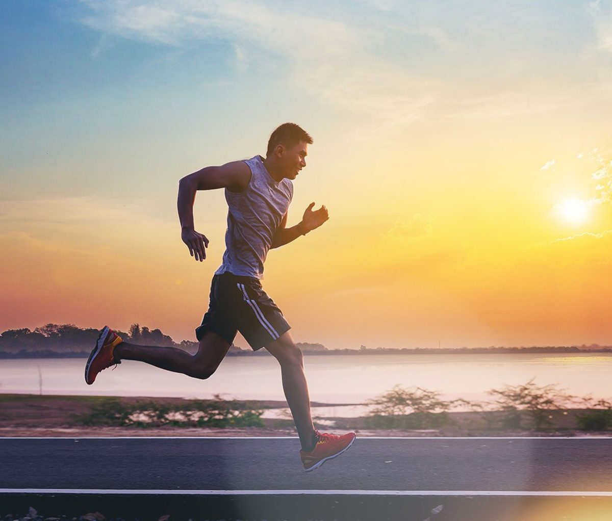 A man doing beginner sprint workouts on the road.