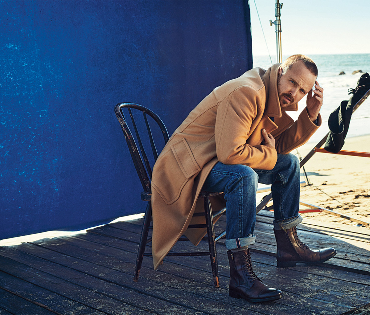 Paul wears coat by Mr P; jeans by The Workers Club Denim; boots by Kenneth Cole