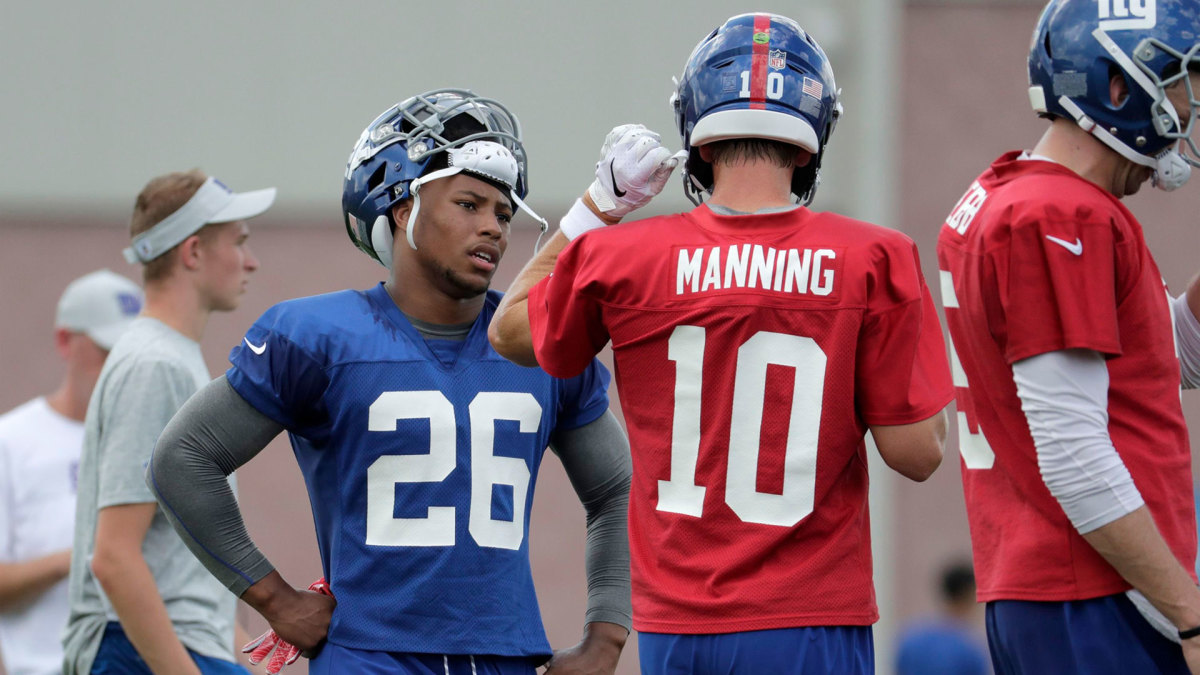 Giants Football, East Rutherford, USA - 26 Jul 2018 New York Giants running back Saquon Barkley, left, talks to quarterback Eli Manning before running a play at NFL football training camp, in East Rutherford, N.J 26 Jul 2018