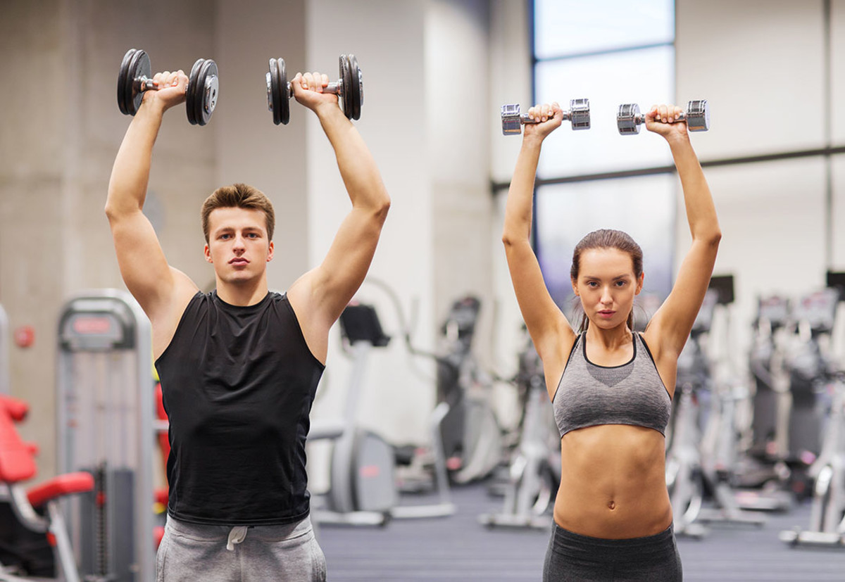 Dumbbell Push Press Man and Woman in Gym