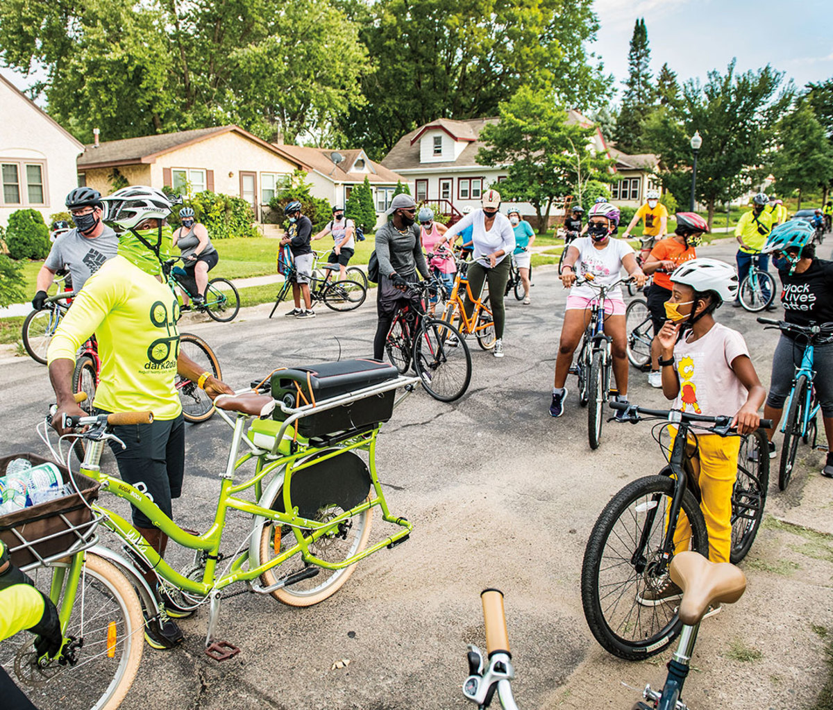 Taylor, masked up (in green) to lead the Sept. 5 community Slow Roll, launching four blocks west of the George Floyd Memorial Site.