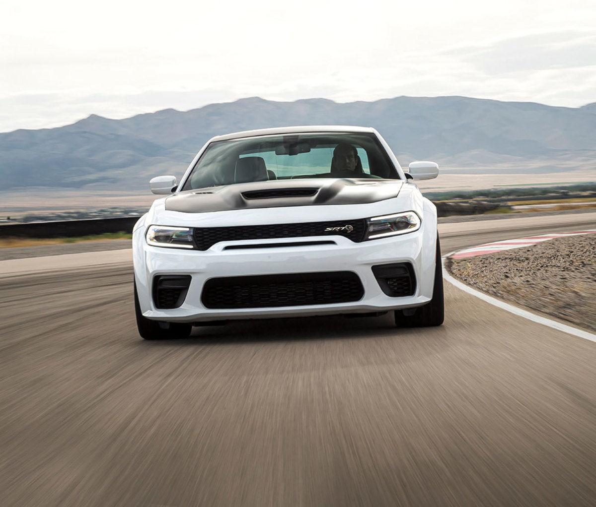 White and black sport car racing toward camera