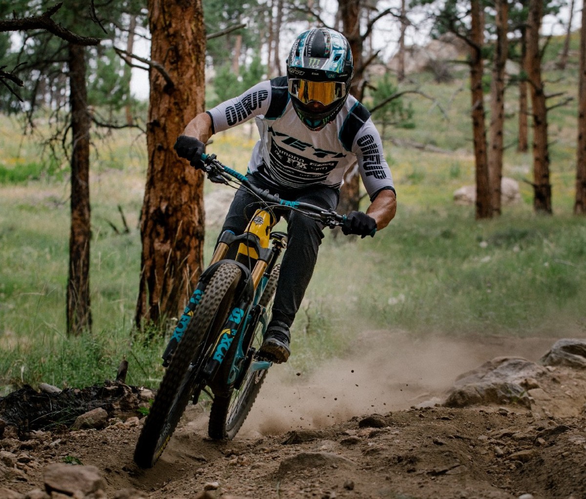 Man riding electric mountain bike in full helmet and goggles