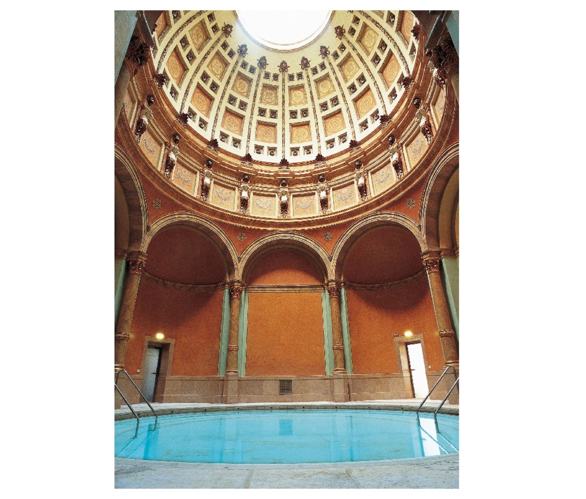 Indoor thermal pool and ornate Neo-Renaissance structure of Friedrichsbad Spa