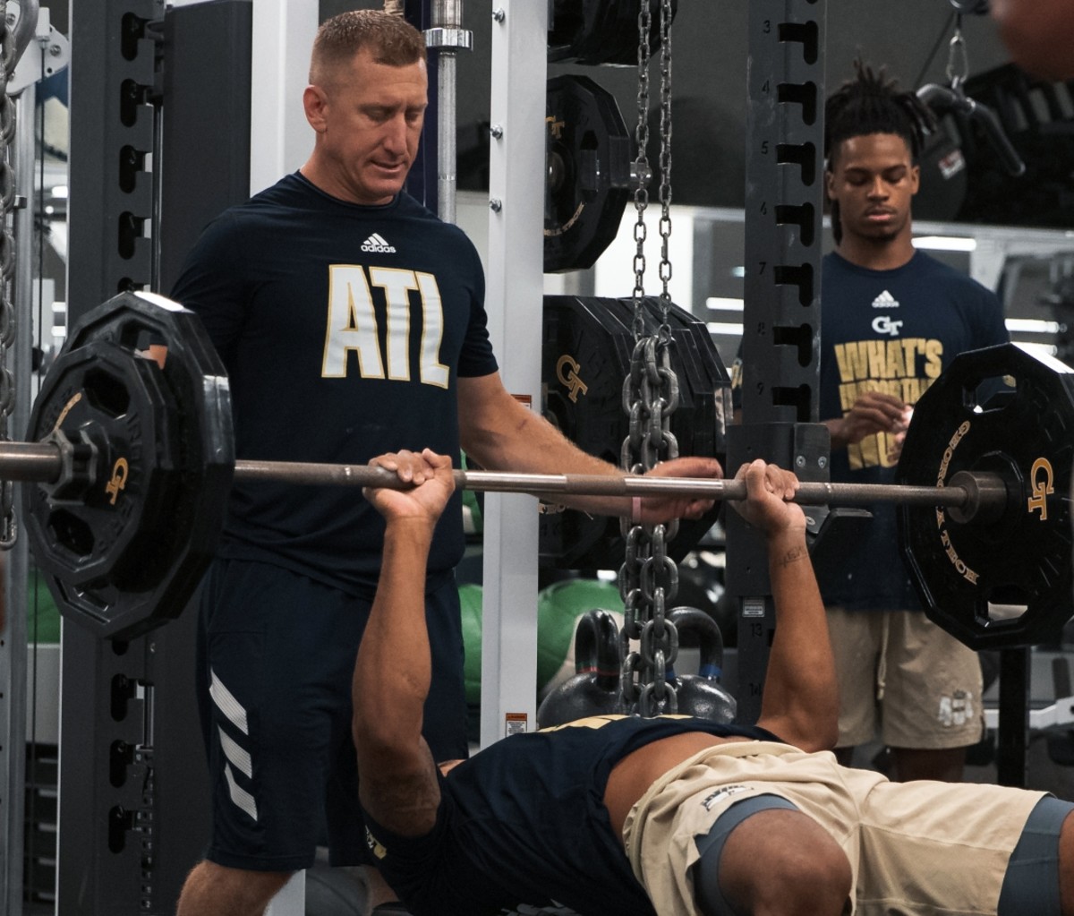 Lew Caralla spotting a player at the bench press