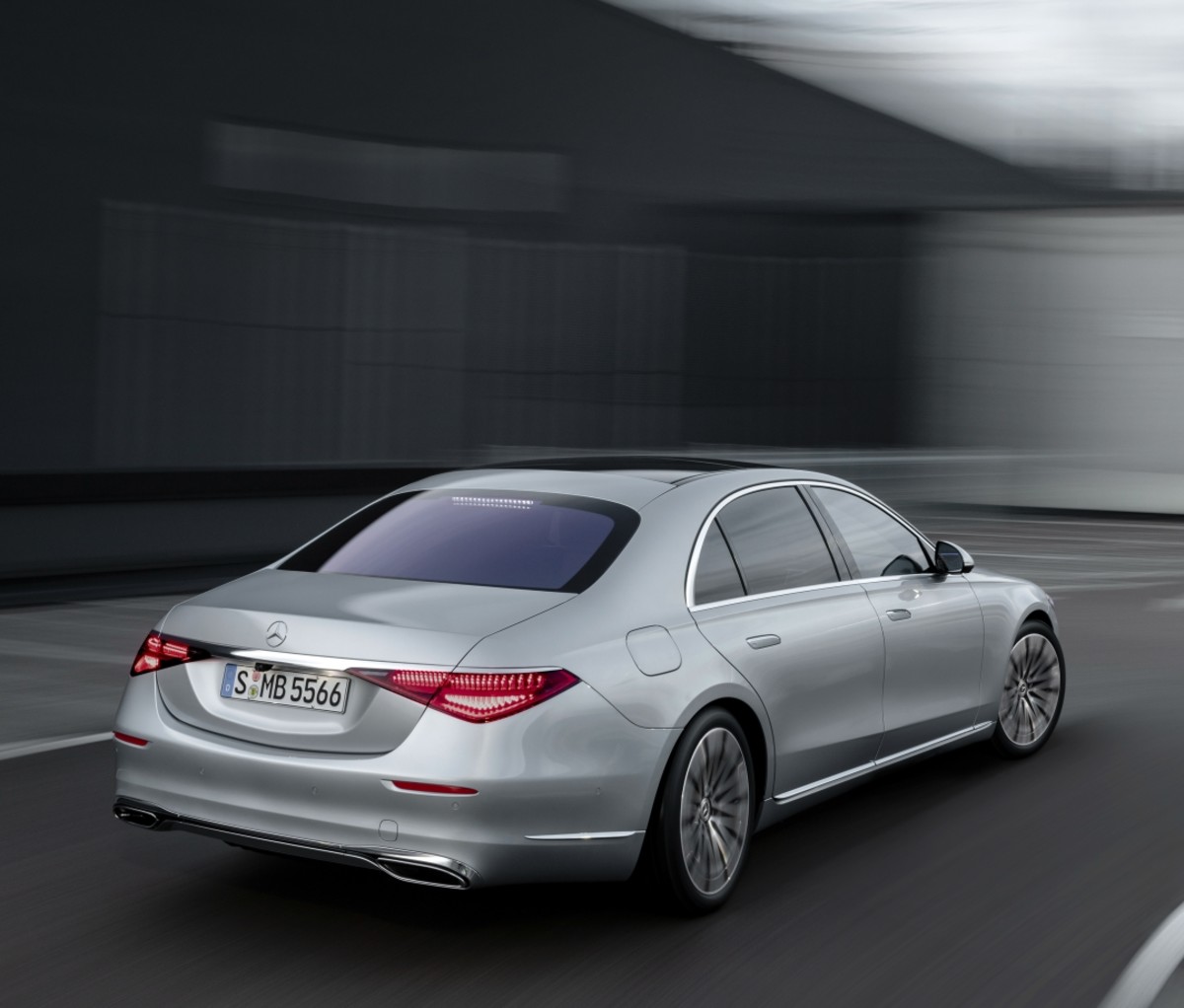 A grey 2021 Mercedes-Benz S-Class sedan driving, seen from the rear