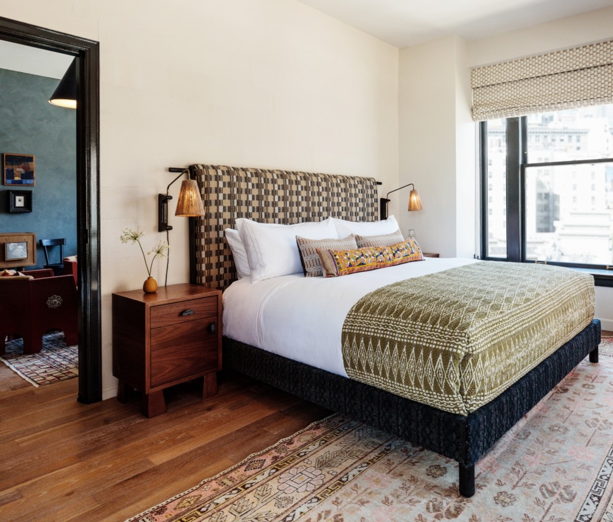 DTLA Proper Hotel room with a bed, wood floors, and a window