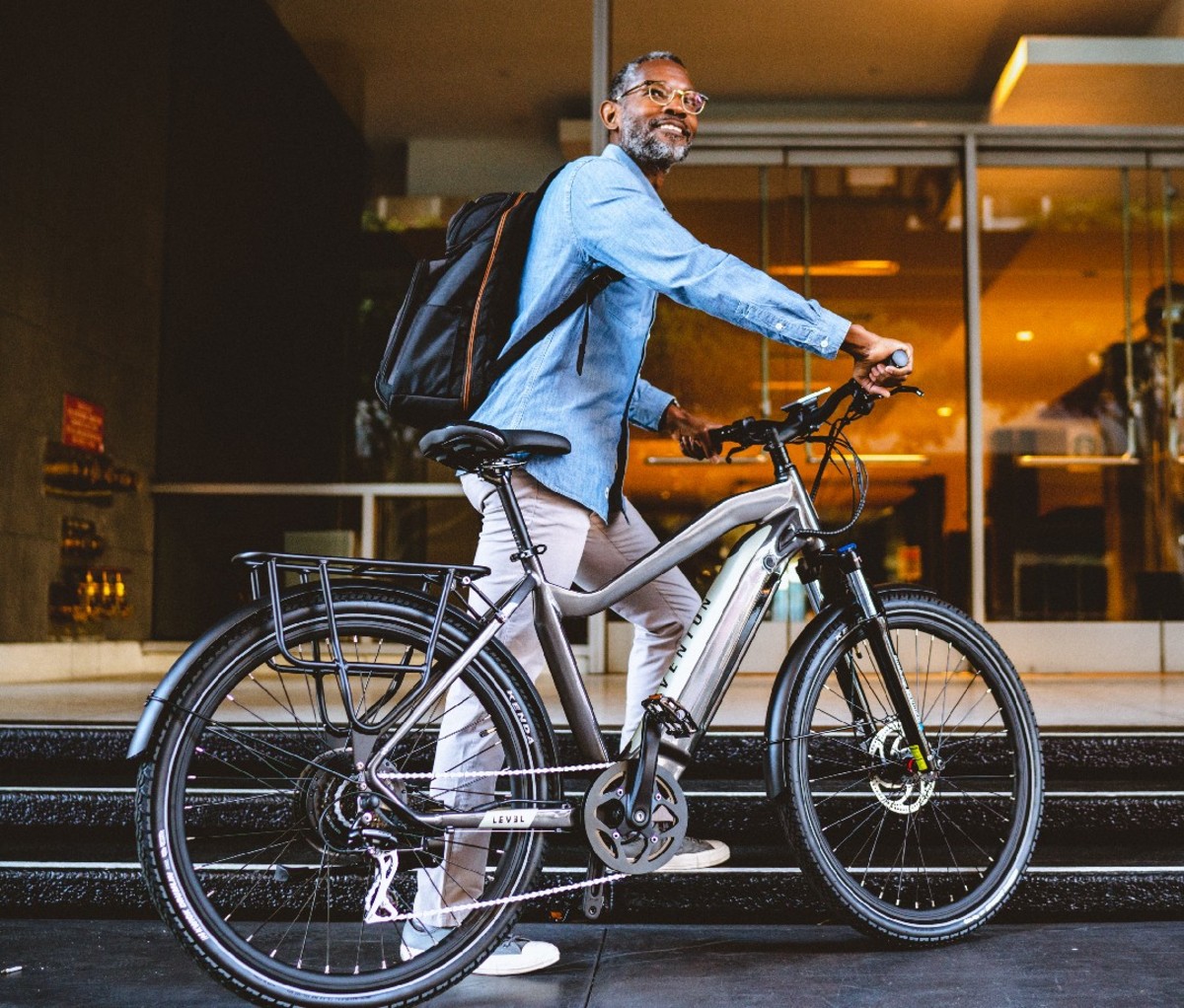 Man standing beside an Aventon Level Ebike