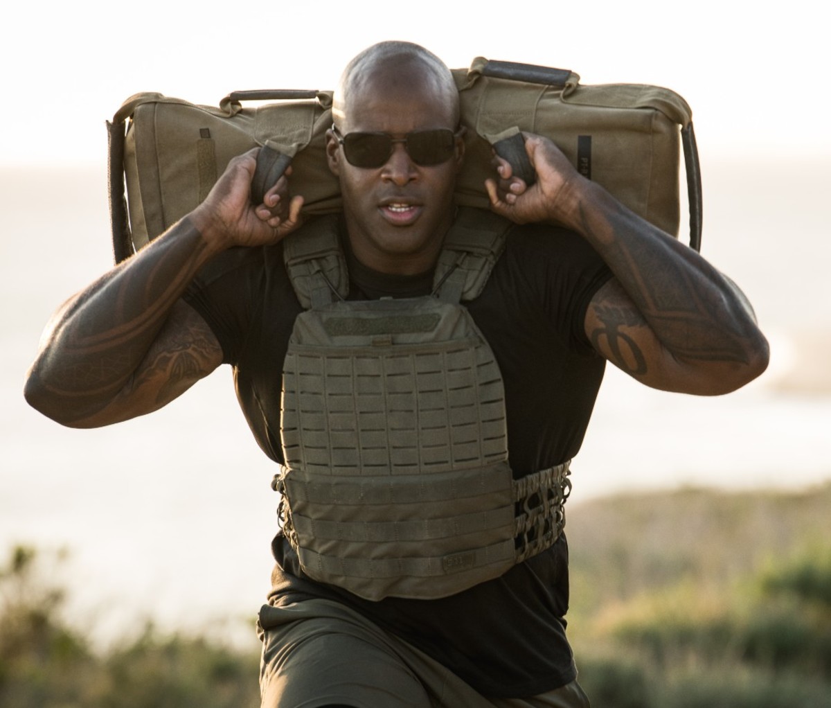 Man carrying weighted bag on shoulders