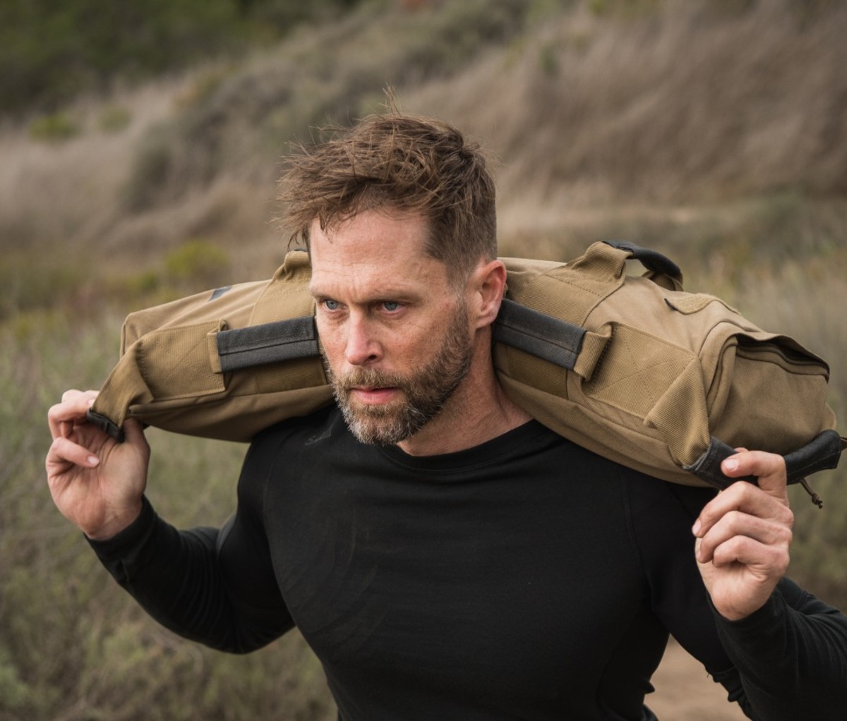 Man carrying weighted bag on shoulders