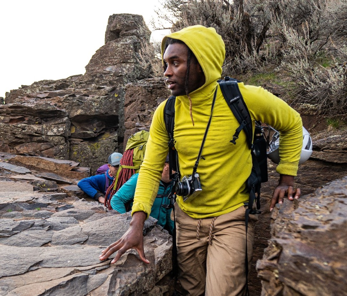 Hikers wind through a narrow canyon trail