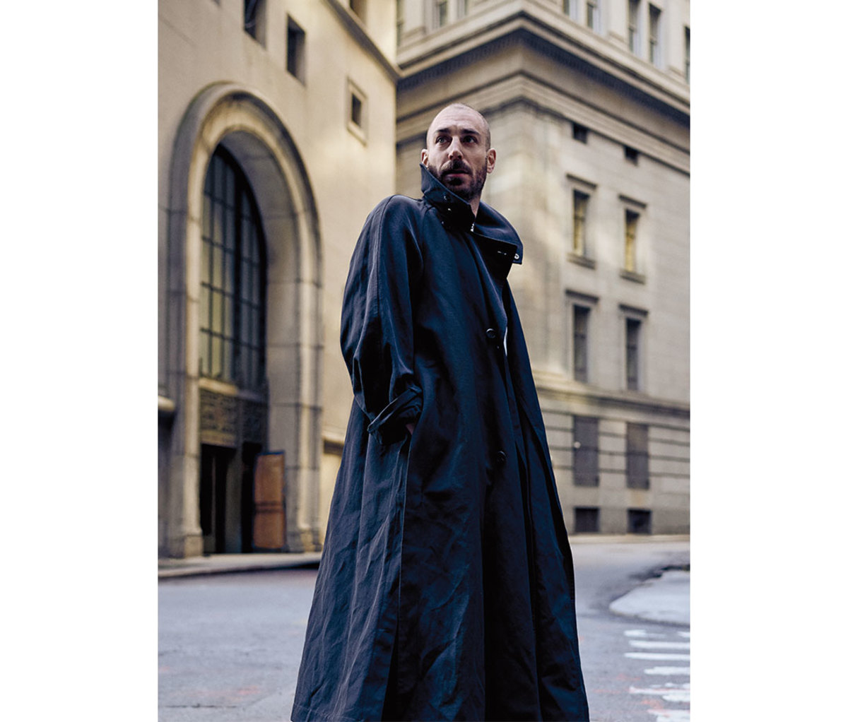 Caucasian man wearing oversized trench coat