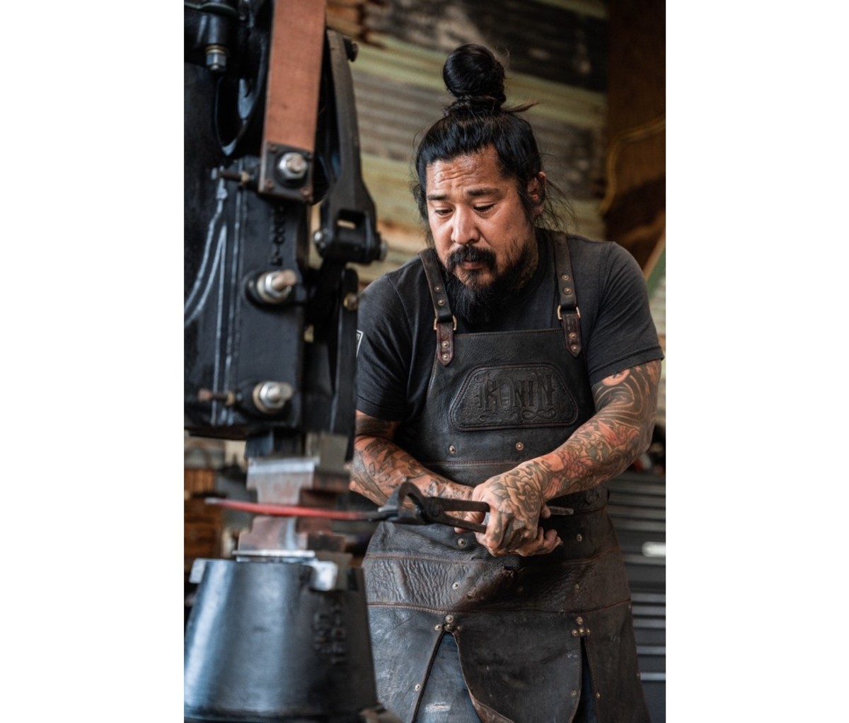 Neil Kamimura working at his Cole Ironworks 25 ton hydraulic forging press.