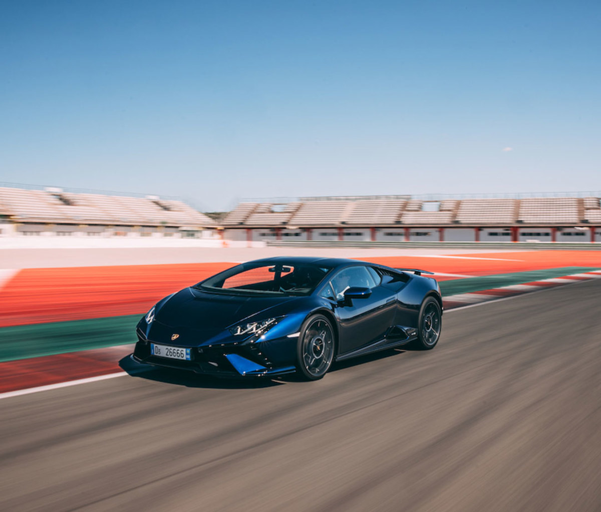 Blue sports car racing around race track