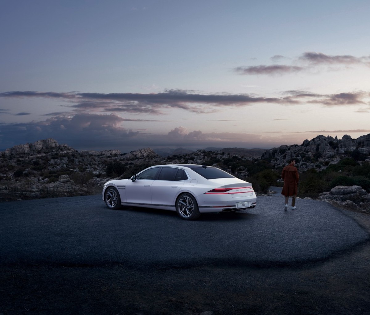 Exterior of silver luxury sedan parked outside at sunset