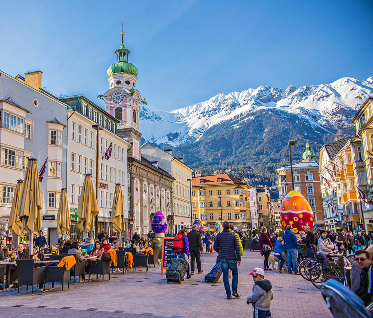 Innsbruck town center with lots of people and street cafes.