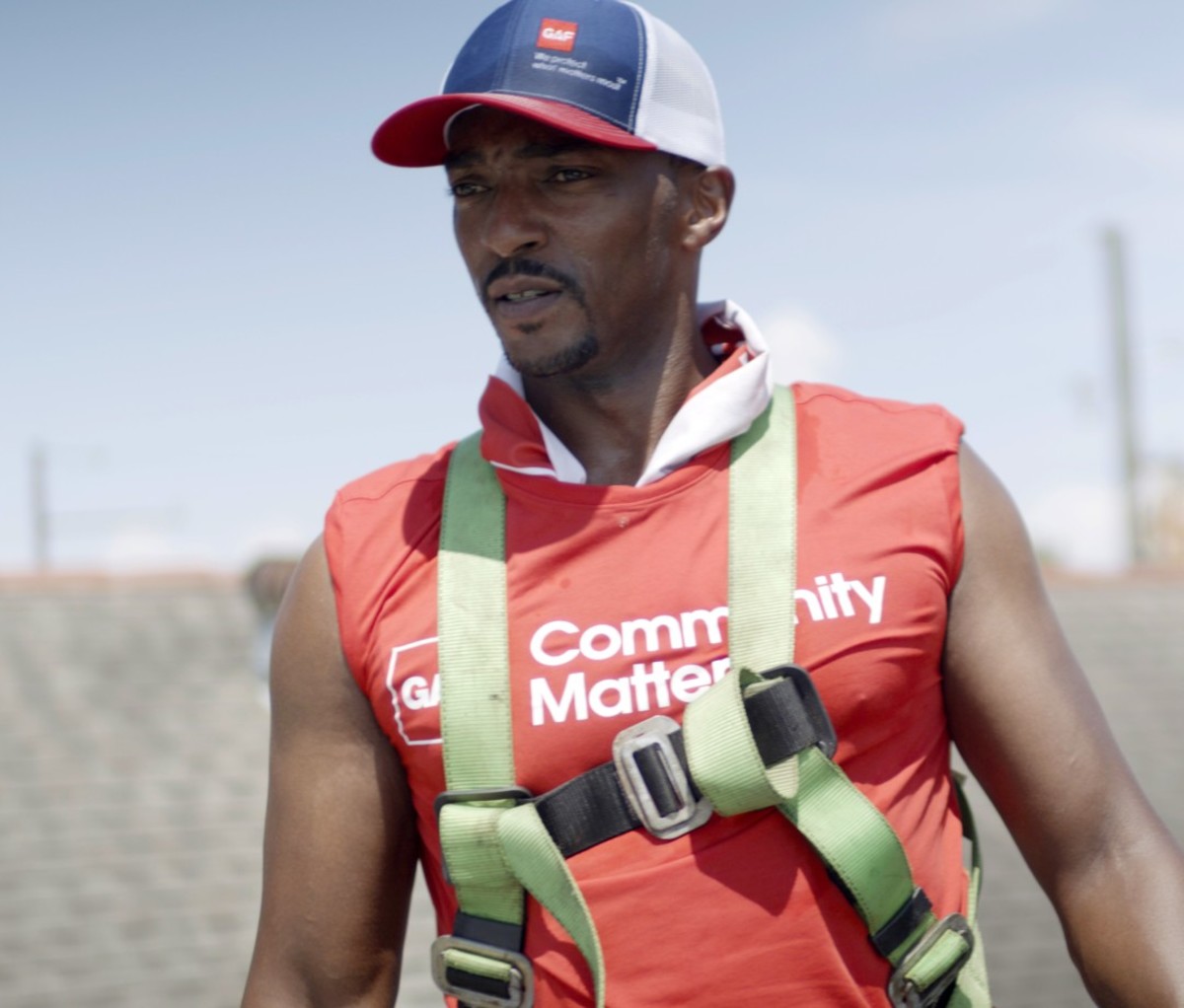 Black man in red T-shirt and trucker hat