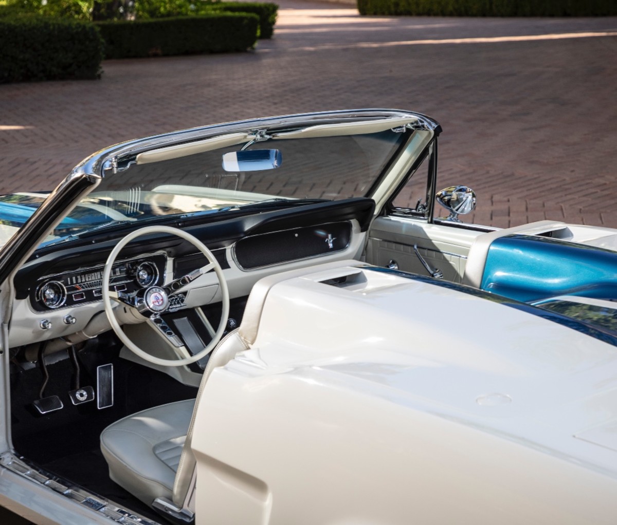 OVC Ford Mustang Roadster in a courtyard.