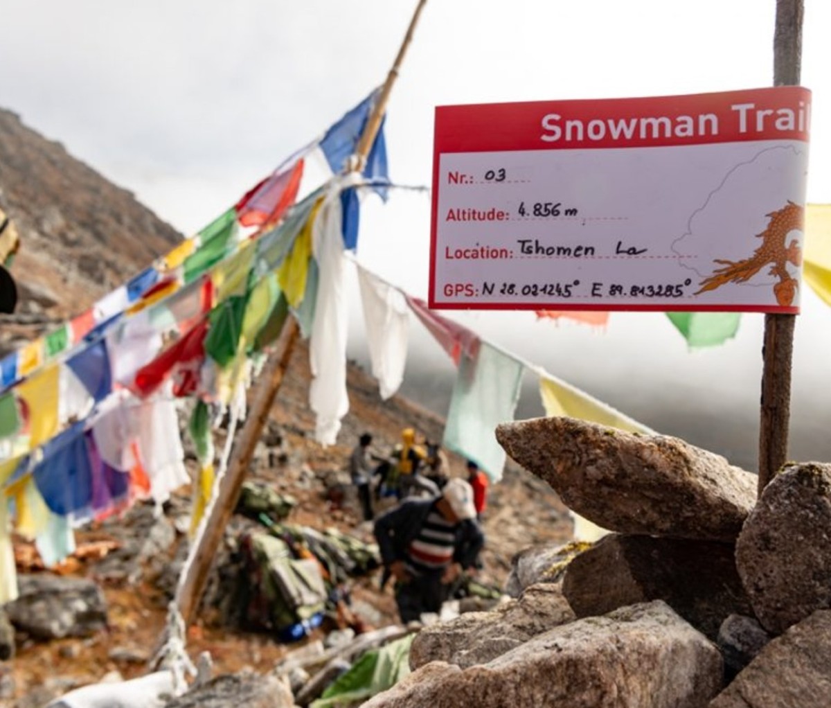 Snowman Trek signage and flags on mountainside