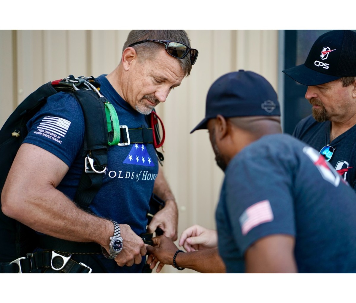 Man getting harness safety check before skydiving