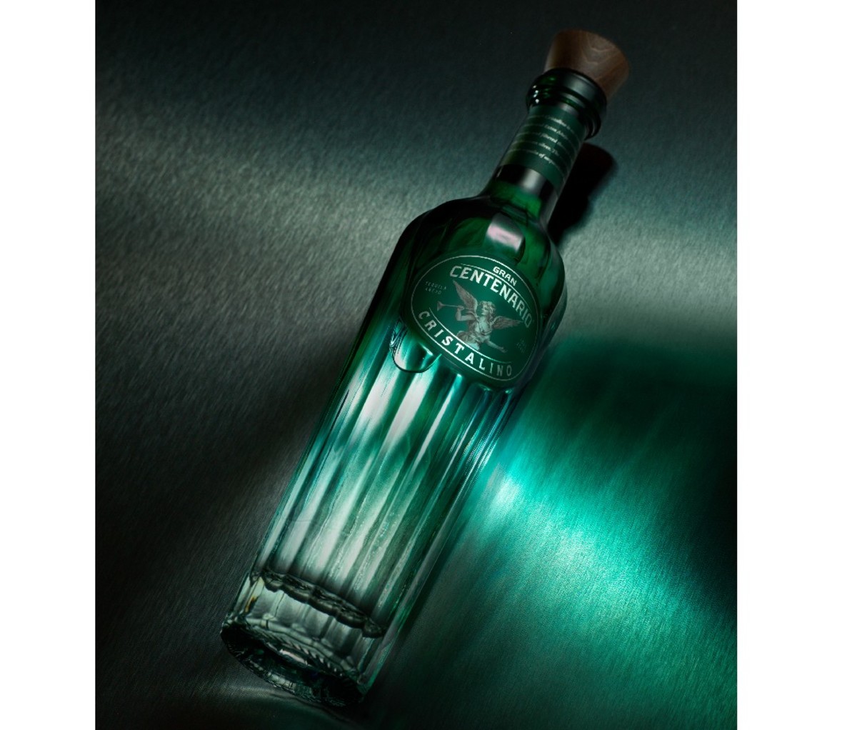 Bottle of Gran Centenario Cristalino against dark background.