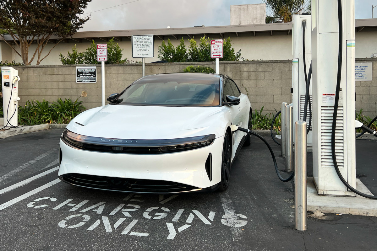 White Lucid Air EV charging up at an electric car charging station.