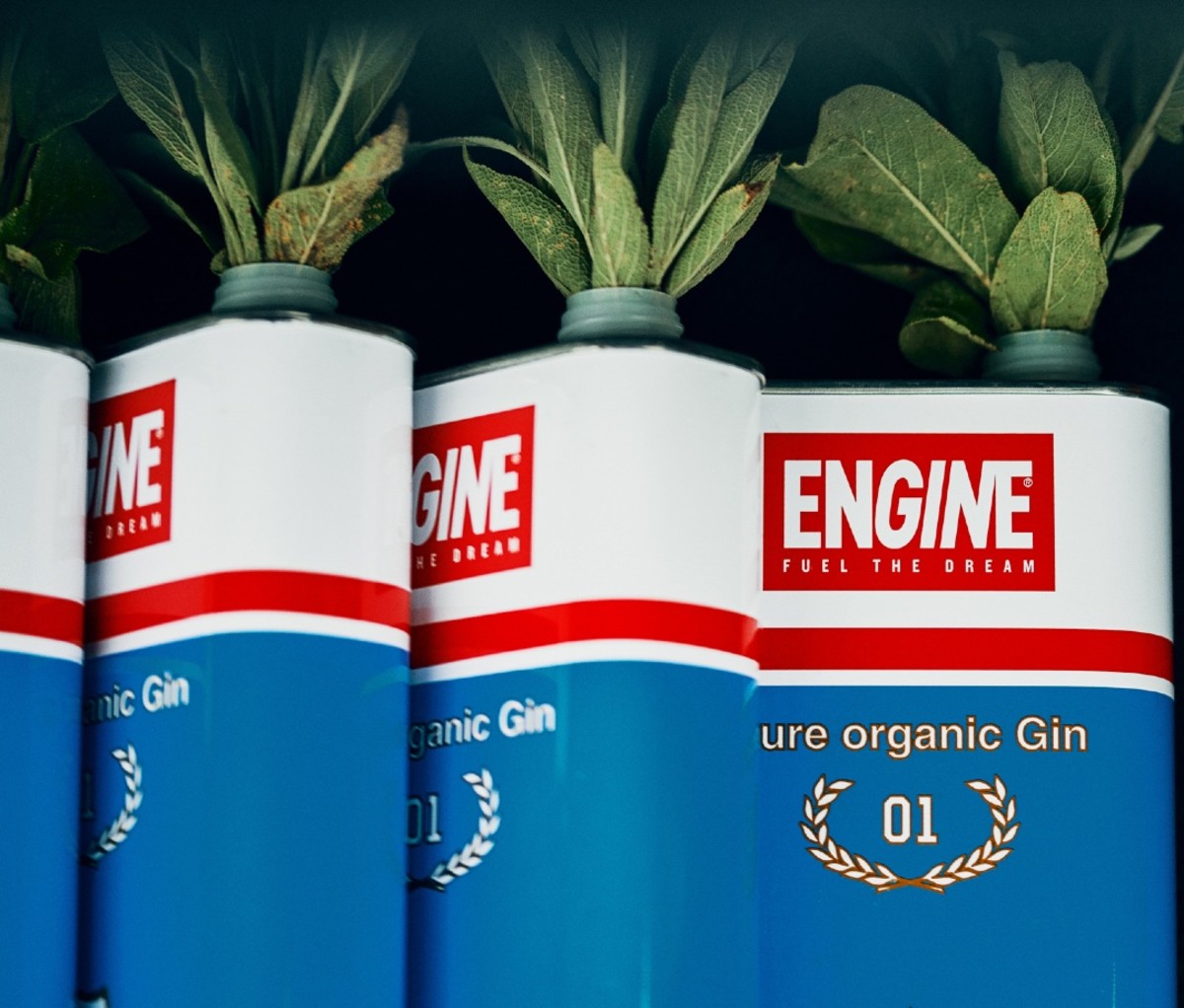 Cans of ENGINE organic gin with sprigs of sage