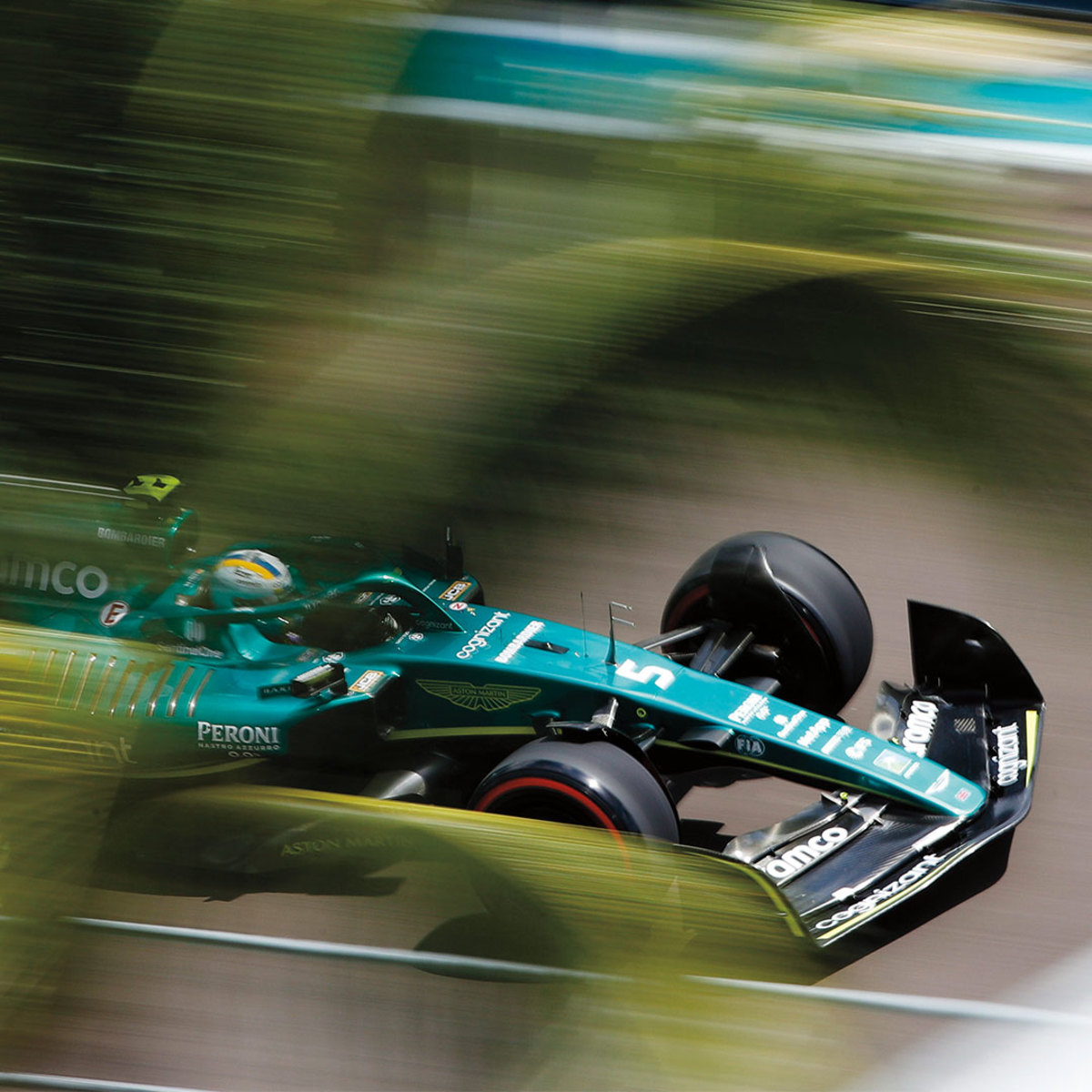 Teal Formula 1 race car in motion on track