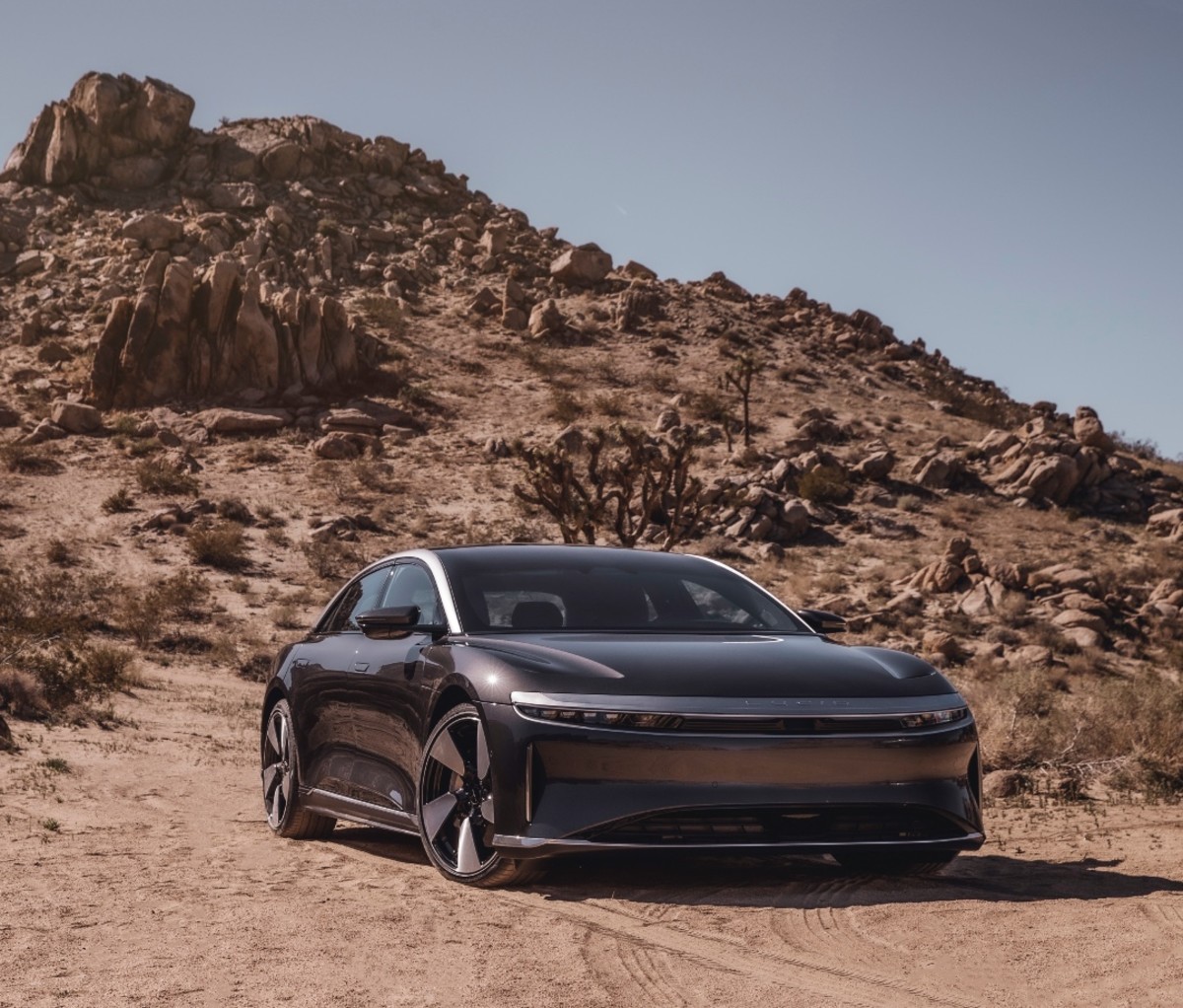 Brown Lucid Air EV with desert in the background.