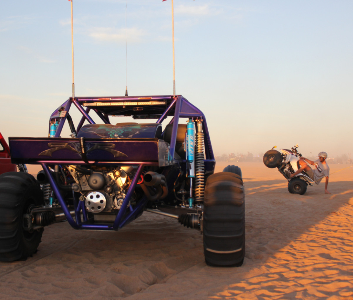 Rider hanging out at Camp RZR, with side-by-side in foreground.