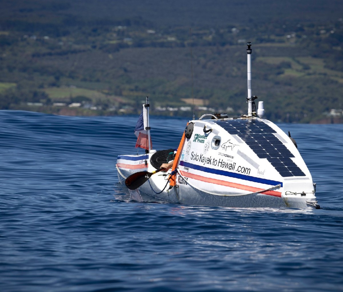 Cyril Derreumaux paddling toward Hilo, HI. Rear angle.