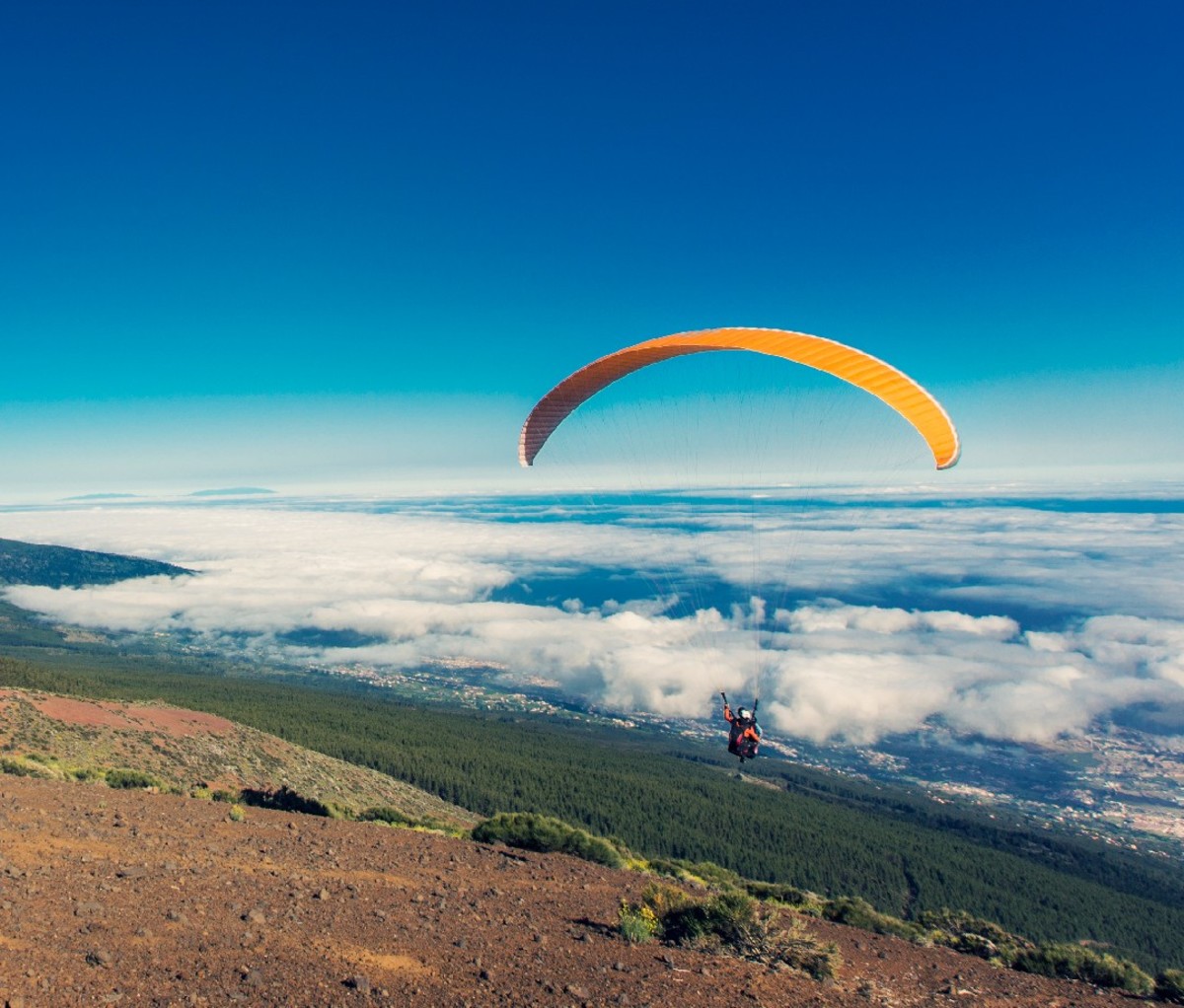 Paraglider launching from a mountain slope on Tenerife.