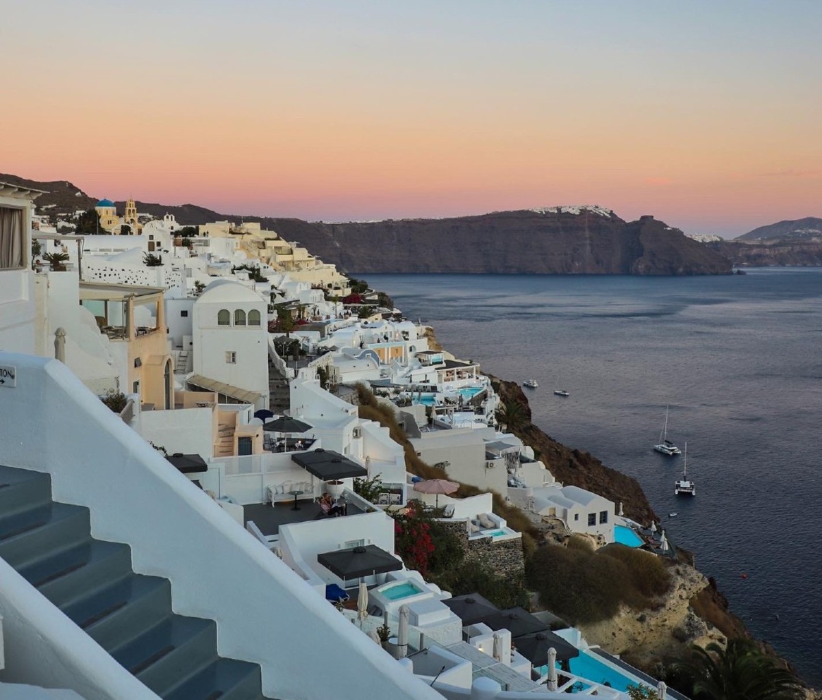 Cliffside white-washed dwellings at sunset