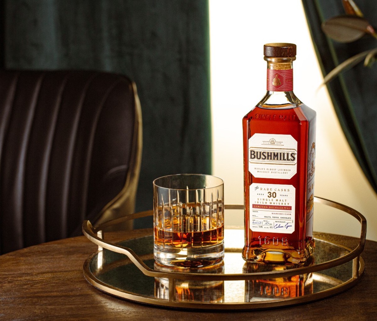 Bottle of Bushmills Rare Cask #3 with dram of whiskey